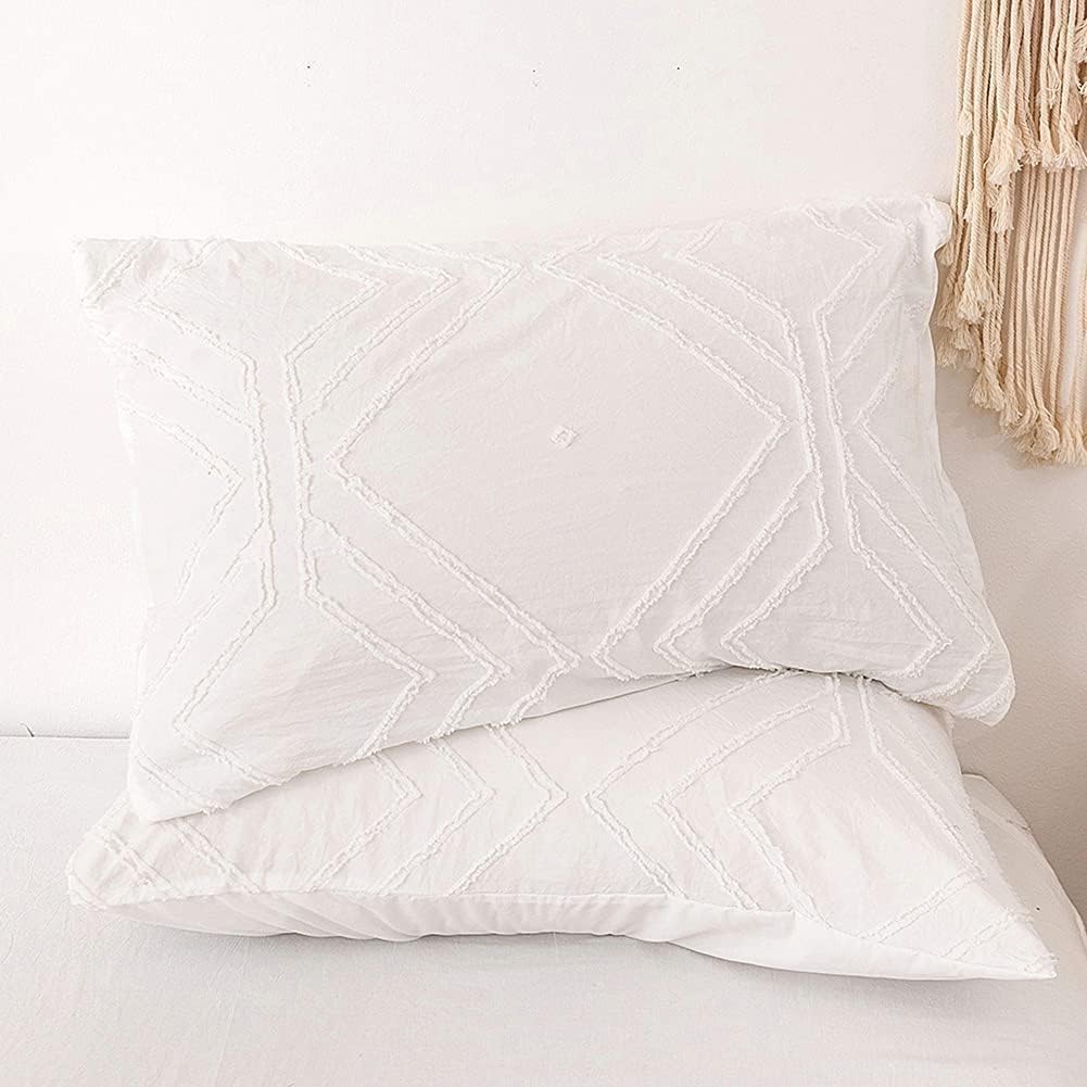 Close-up of the VibeCore Aesthetic Free Spirit Tufted Duvet Cover Set pillowcases in white, showcasing the soft, tufted texture and detailed design. The pillowcases complement the duvet cover, adding a cozy, boho-chic touch to your bedding ensemble.