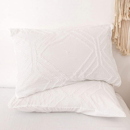 Close-up of the VibeCore Aesthetic Free Spirit Tufted Duvet Cover Set pillowcases in white, showcasing the soft, tufted texture and detailed design. The pillowcases complement the duvet cover, adding a cozy, boho-chic touch to your bedding ensemble.