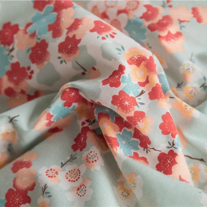 Close-up of the VibeCore Aesthetic Japanese Blossom Duvet Cover pattern, showcasing delicate Japanese-inspired floral motifs in soft, soothing colors, crafted from breathable cotton for a serene and elegant bedroom or dorm ambiance.
