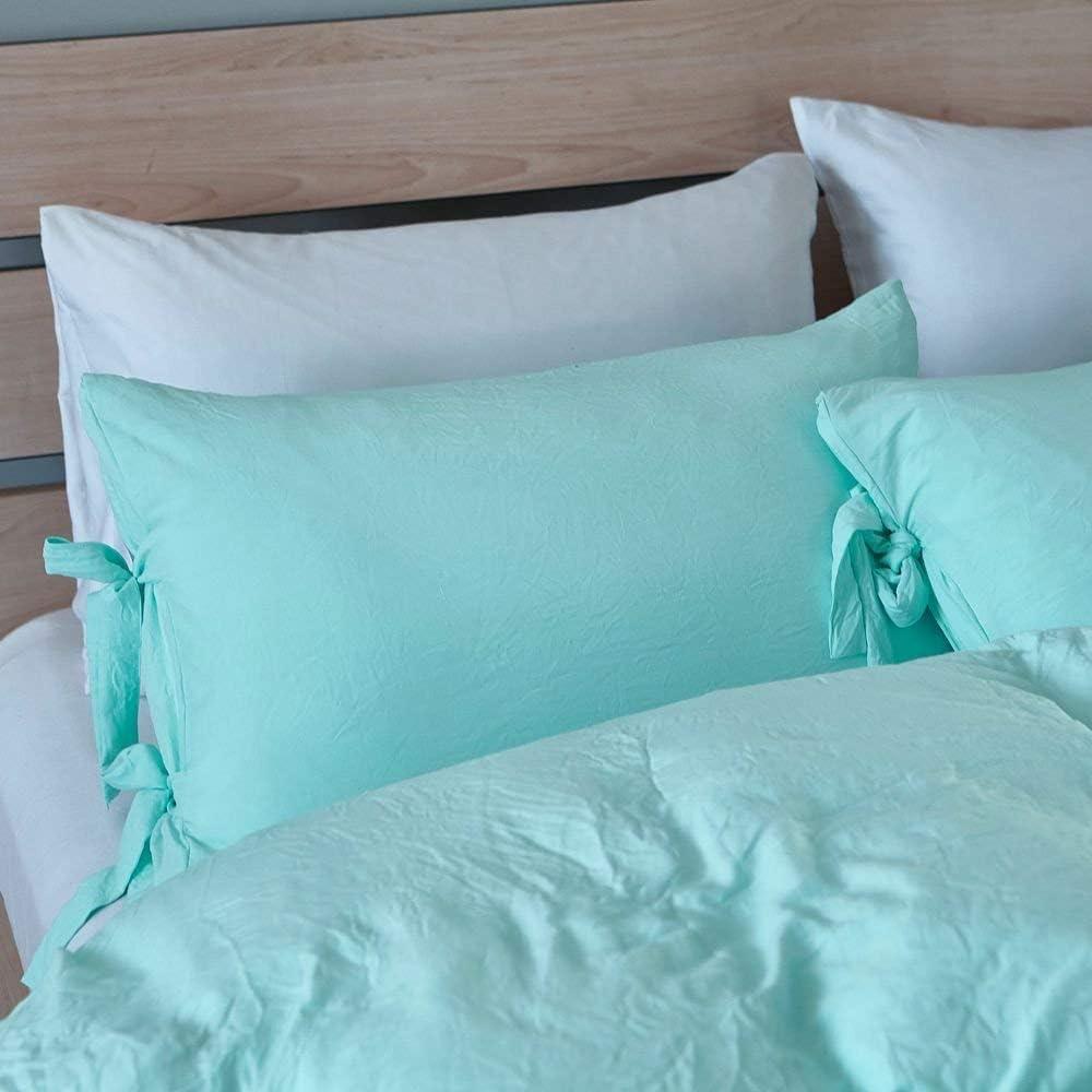 Close-up of the aqua pillowcase from the VibeCore Aesthetic Knot So Ordinary Duvet Cover Set, featuring a soft, textured fabric with unique knot edge detailing for an added cozy, stylish vibe to your bedroom or dorm. 