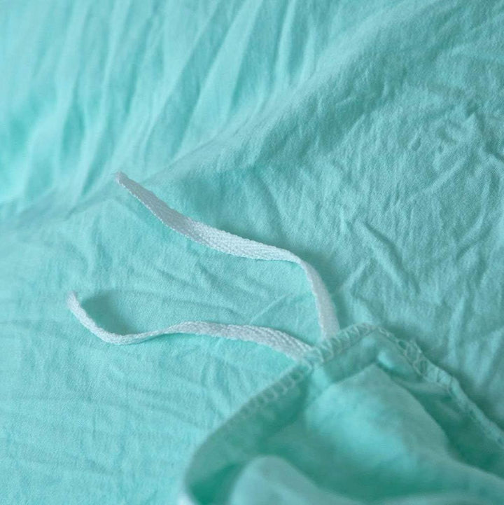 Close-up of the stylish tie feature on the aqua duvet cover from the VibeCore Aesthetic Knot So Ordinary Duvet Cover Set, showcasing the trendy design detail that adds a unique, fashionable touch to your bedding.
