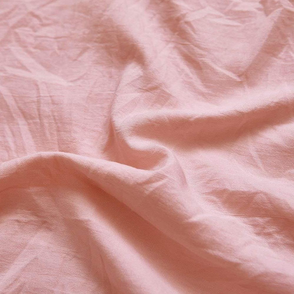 Close-up of the VibeCore Aesthetic Knot So Ordinary Duvet Cover Set in baby pink, showcasing the soft and textured material and vibrant pastel color, adding a cozy and stylish touch to your bedding.