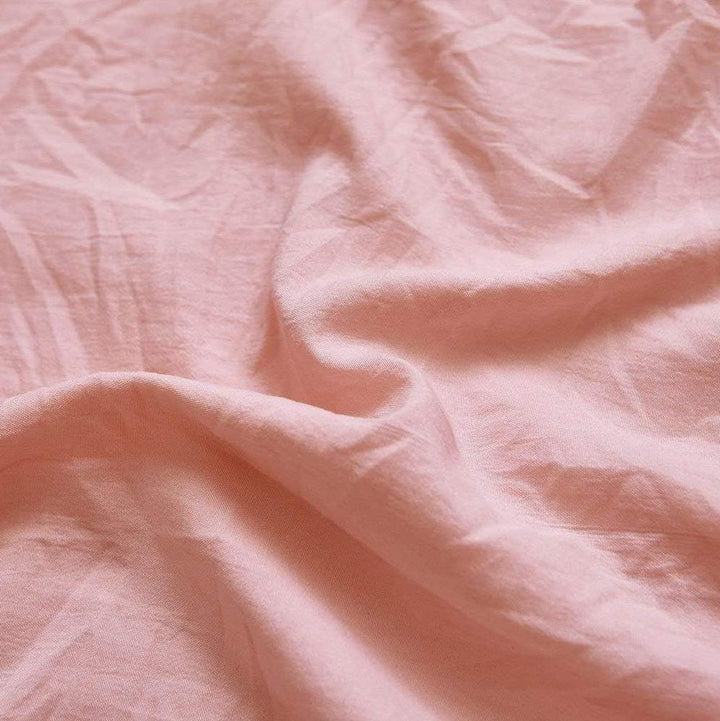 Close-up of the VibeCore Aesthetic Knot So Ordinary Duvet Cover Set in baby pink, showcasing the soft and textured material and vibrant pastel color, adding a cozy and stylish touch to your bedding.