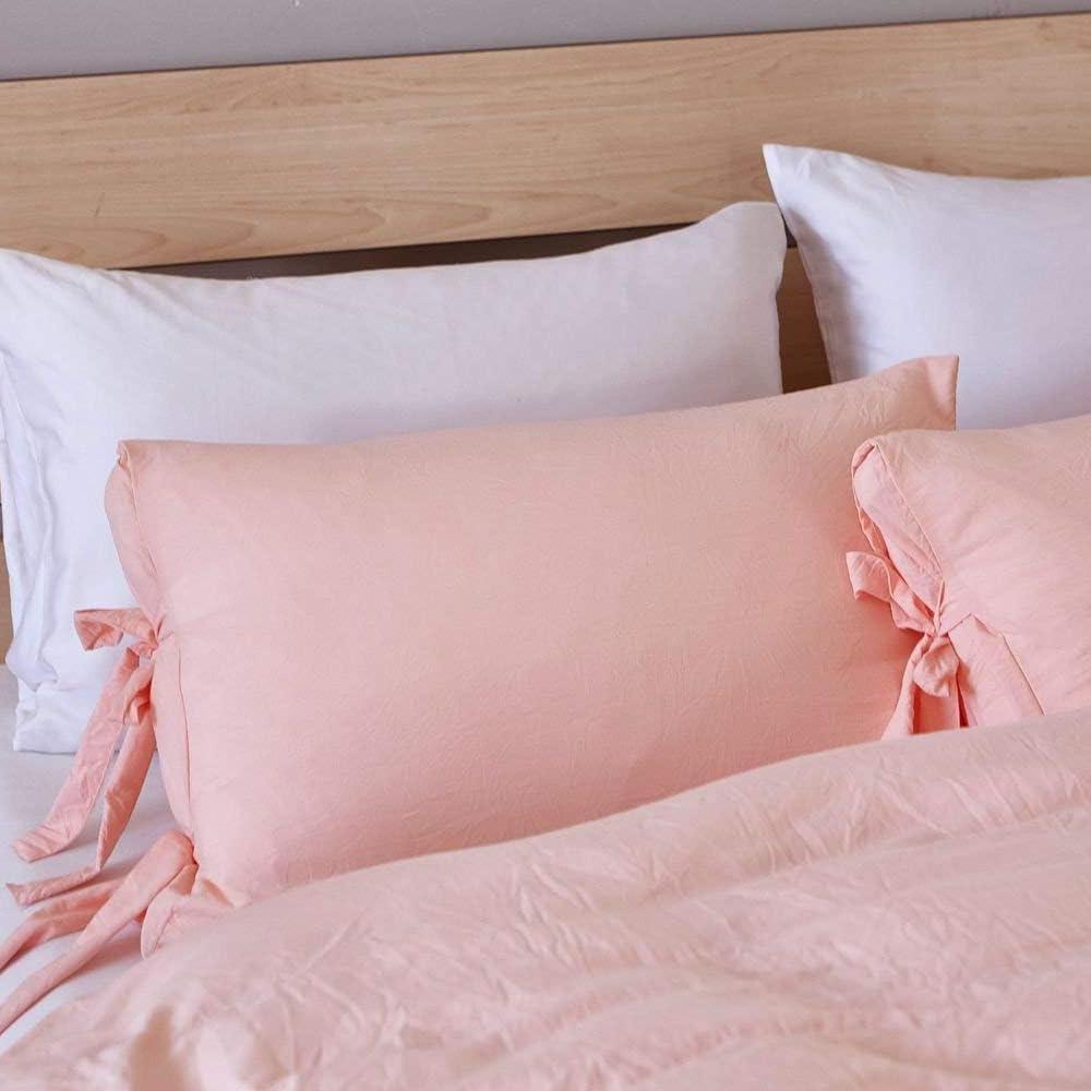 Close-up of the baby pink pillowcase from the VibeCore Aesthetic Knot So Ordinary Duvet Cover Set, featuring a soft, textured fabric with unique knot edge detailing for an added cozy, stylish vibe to your bedroom or dorm. 