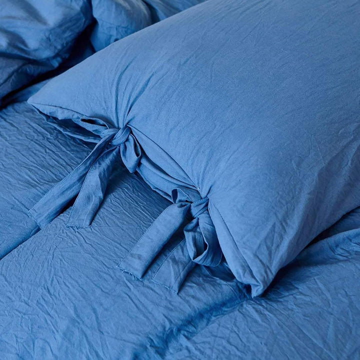 Close-up of the intricate knot detail on the blue duvet cover from the VibeCore Aesthetic Knot So Ordinary Duvet Cover Set, highlighting the unique texture and stylish design for a cozy, chic bedroom or dorm look.