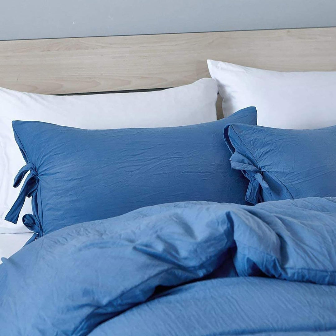 Close-up of the blue pillowcase from the VibeCore Aesthetic Knot So Ordinary Duvet Cover Set, featuring a soft, textured fabric with unique knot edge detailing for an added cozy, stylish vibe to your bedroom or dorm. 