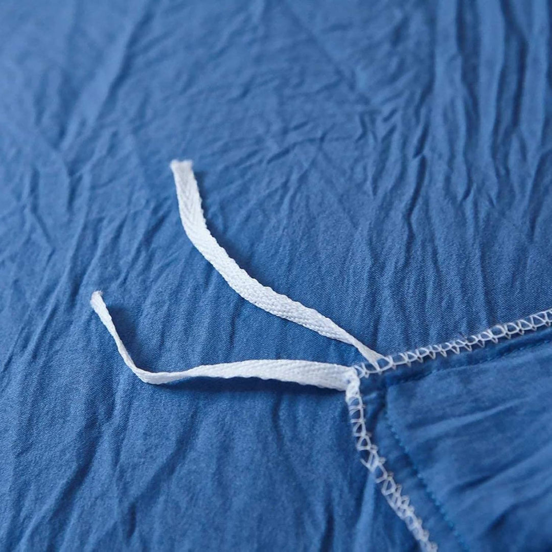 Close-up of the stylish tie feature on the blue duvet cover from the VibeCore Aesthetic Knot So Ordinary Duvet Cover Set, showcasing the trendy design detail that adds a unique, fashionable touch to your bedding.