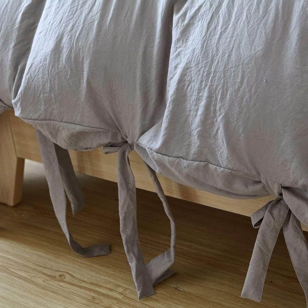 Close-up of the knot ends on the light gray duvet cover from the VibeCore Aesthetic Knot So Ordinary Duvet Cover Set, highlighting the chic knot detail that adds a modern, stylish flair to your bedding.