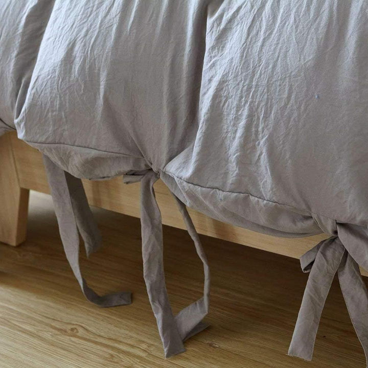 Close-up of the knot ends on the light gray duvet cover from the VibeCore Aesthetic Knot So Ordinary Duvet Cover Set, highlighting the chic knot detail that adds a modern, stylish flair to your bedding.