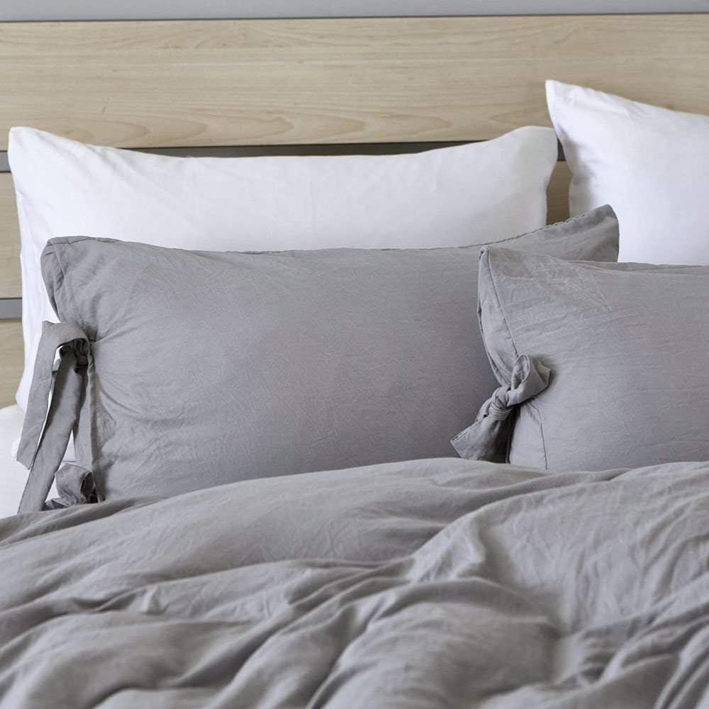 Close-up of the light gray pillowcase from the VibeCore Aesthetic Knot So Ordinary Duvet Cover Set, featuring a soft, textured fabric with unique knot edge detailing for an added cozy, stylish vibe to your bedroom or dorm. 