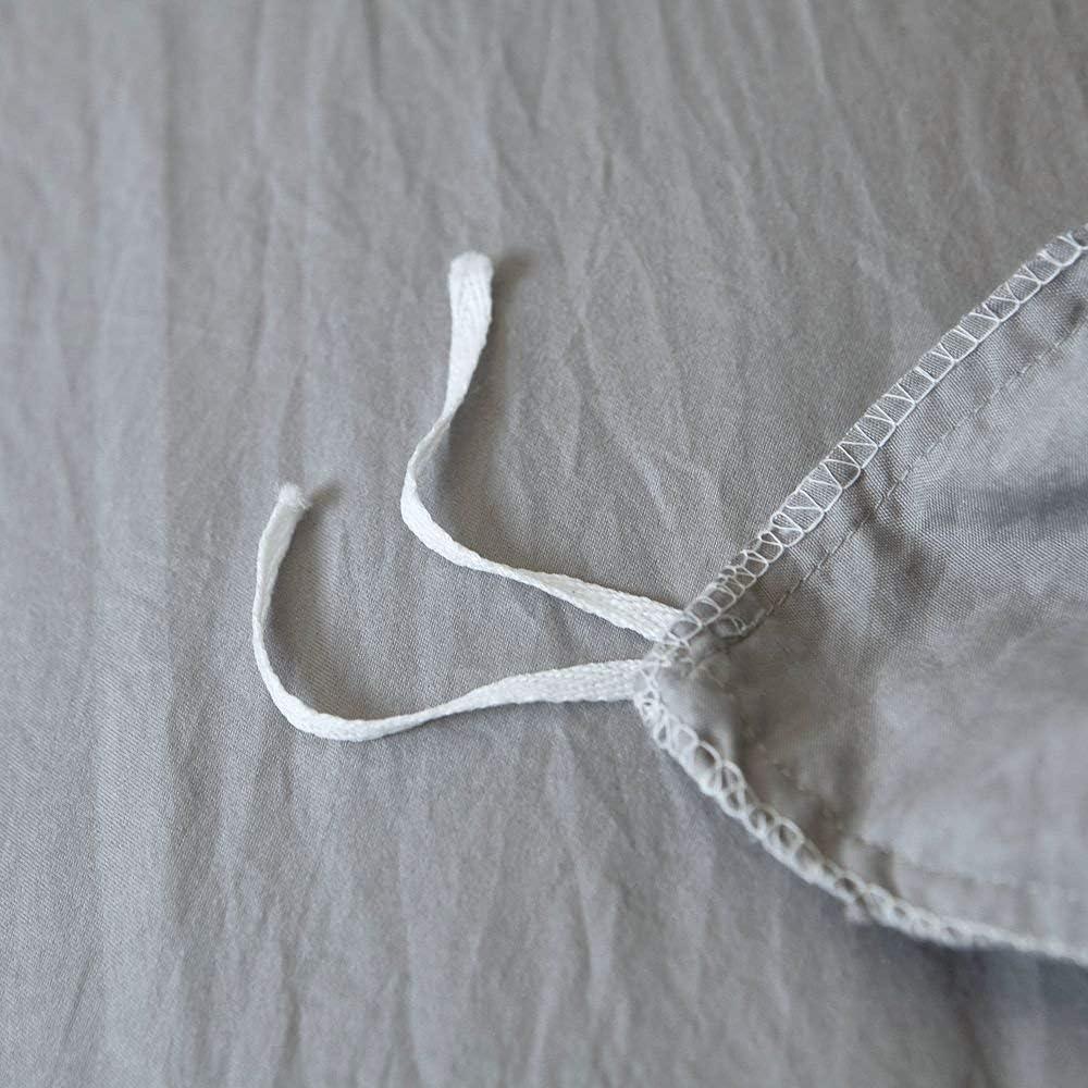 Close-up of the stylish tie feature on the light gray duvet cover from the VibeCore Aesthetic Knot So Ordinary Duvet Cover Set, showcasing the trendy design detail that adds a unique, fashionable touch to your bedding.
