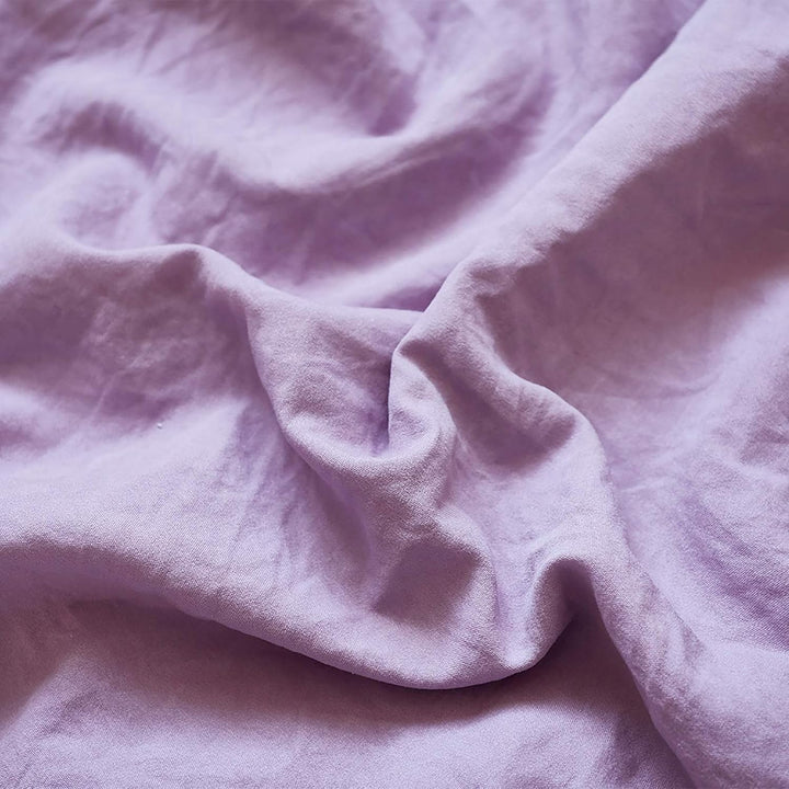 Close-up of the VibeCore Aesthetic Knot So Ordinary Duvet Cover Set in lilac, showcasing the soft and textured material and vibrant pastel color, adding a cozy and stylish touch to your bedding.