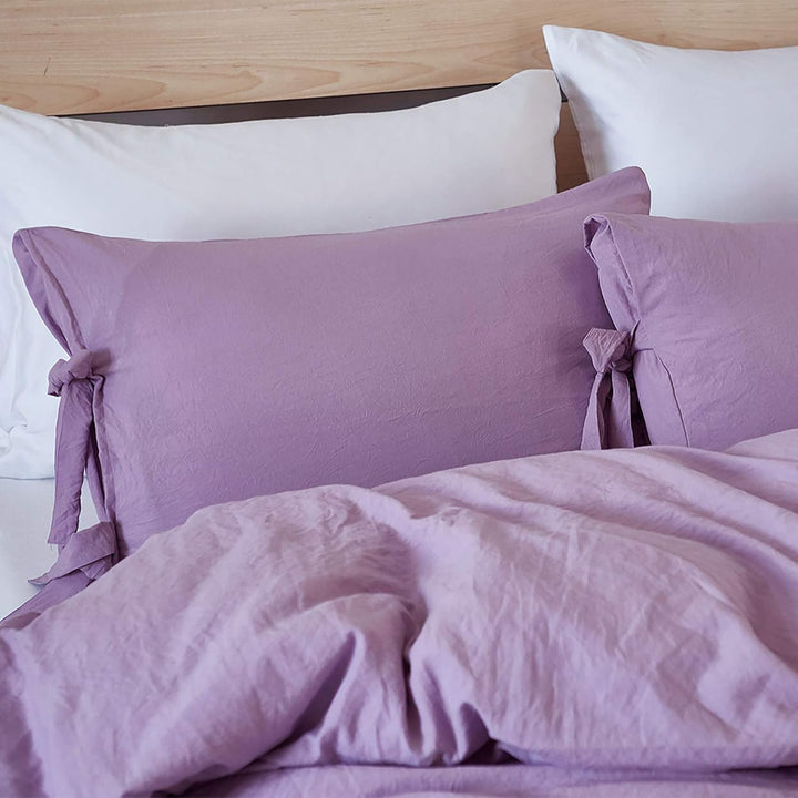 Close-up of the lilac pillowcase from the VibeCore Aesthetic Knot So Ordinary Duvet Cover Set, featuring a soft, textured fabric with unique knot edge detailing for an added cozy, stylish vibe to your bedroom or dorm. 