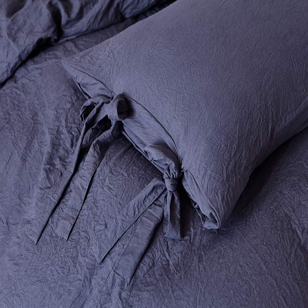 Close-up of the intricate knot detail on the navy blue duvet cover from the VibeCore Aesthetic Knot So Ordinary Duvet Cover Set, highlighting the unique texture and stylish design for a cozy, chic bedroom or dorm look.
