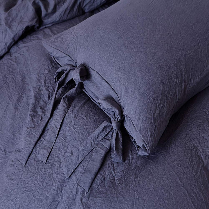 Close-up of the intricate knot detail on the navy blue duvet cover from the VibeCore Aesthetic Knot So Ordinary Duvet Cover Set, highlighting the unique texture and stylish design for a cozy, chic bedroom or dorm look.
