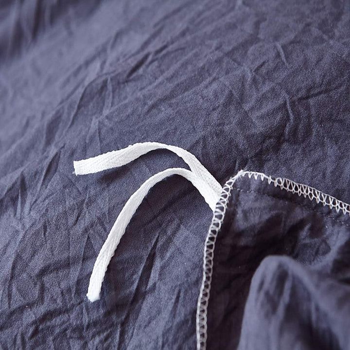 Close-up of the stylish tie feature on the navy blue duvet cover from the VibeCore Aesthetic Knot So Ordinary Duvet Cover Set, showcasing the trendy design detail that adds a unique, fashionable touch to your bedding.
