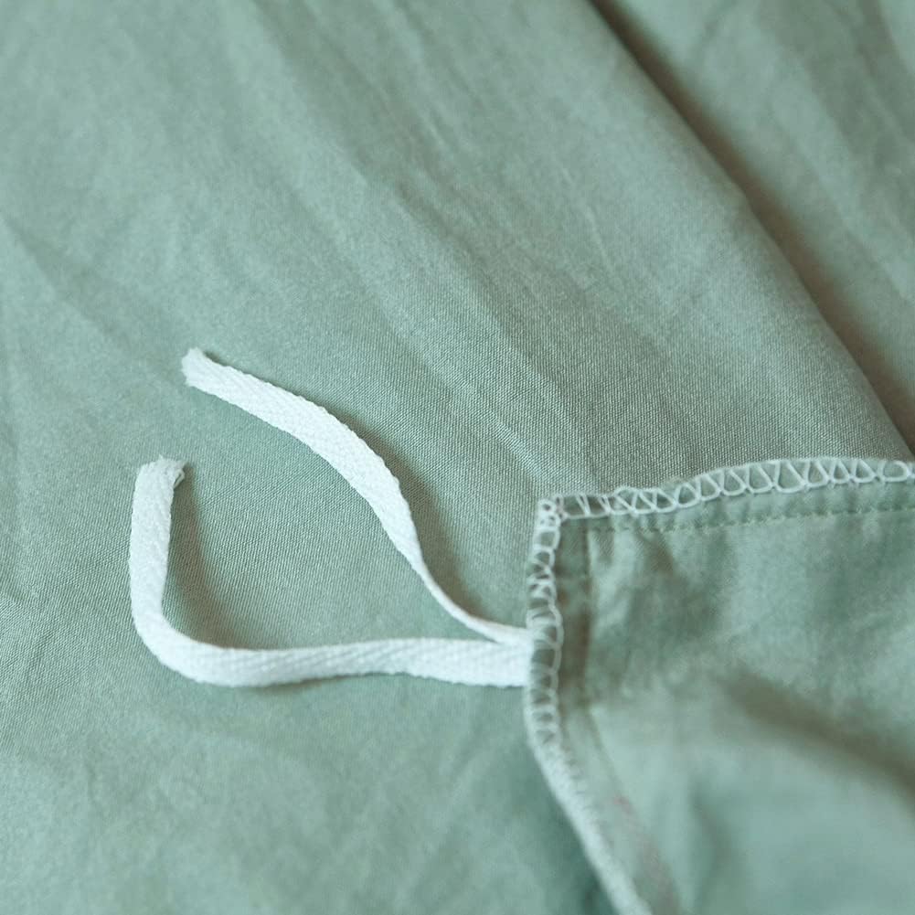 Close-up of the stylish tie feature on the pastel green duvet cover from the VibeCore Aesthetic Knot So Ordinary Duvet Cover Set, showcasing the trendy design detail that adds a unique, fashionable touch to your bedding.