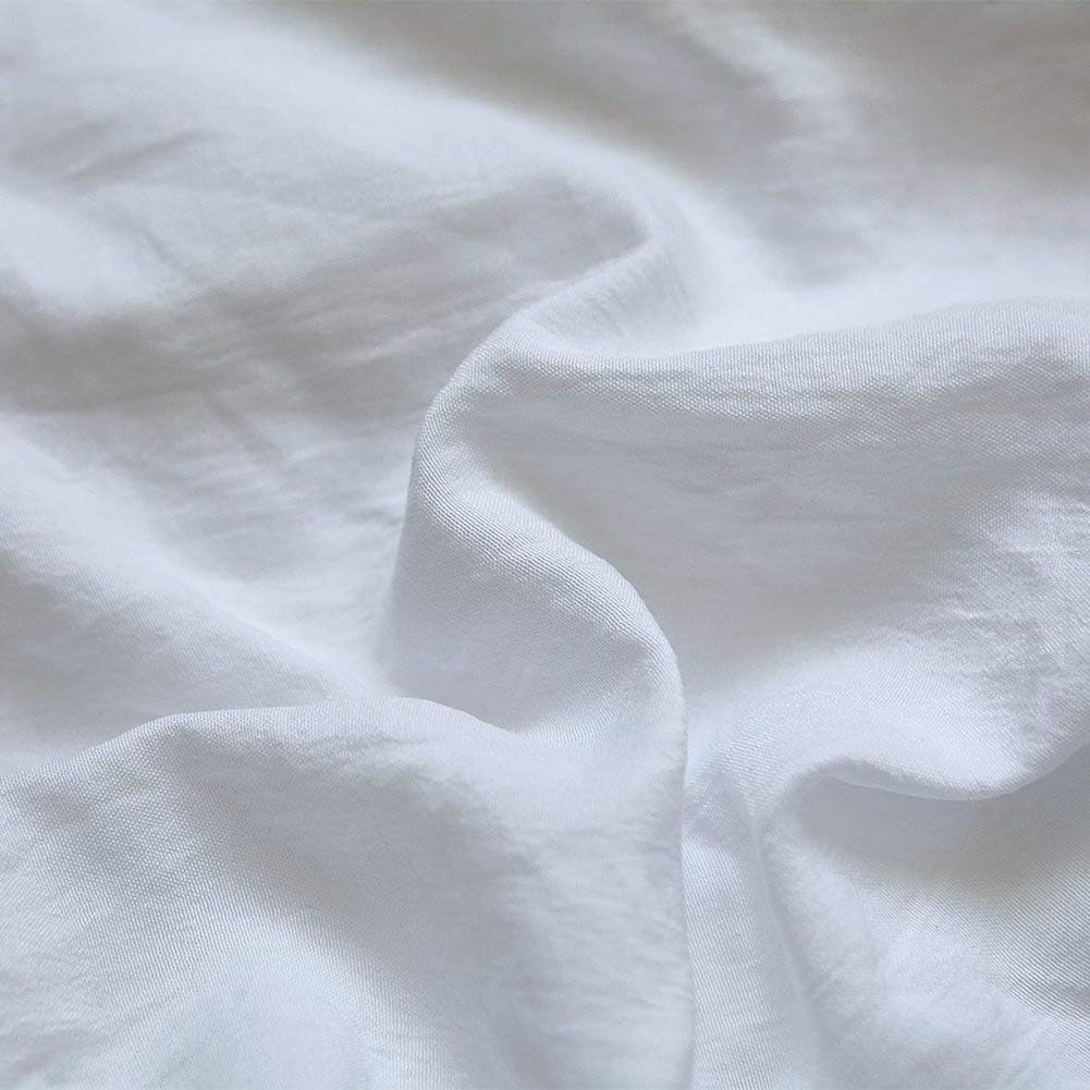 Close-up of the VibeCore Aesthetic Knot So Ordinary Duvet Cover Set in white, showcasing the soft and textured material and vibrant pastel color, adding a cozy and stylish touch to your bedding.