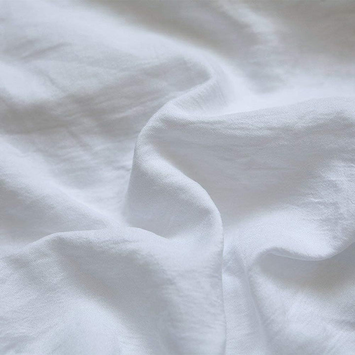 Close-up of the VibeCore Aesthetic Knot So Ordinary Duvet Cover Set in white, showcasing the soft and textured material and vibrant pastel color, adding a cozy and stylish touch to your bedding.
