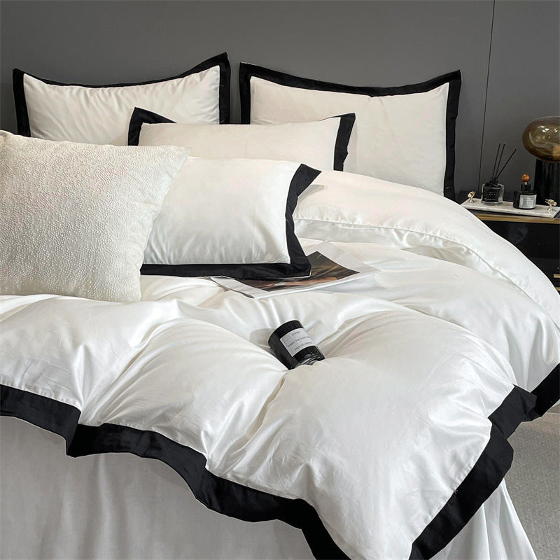 Close-up aerial view of the VibeCore Aesthetic Luxe Noir Trim Duvet Cover Set, featuring a sleek black trim that adds a touch of sophistication to the soft, luxurious fabric, perfect for elevating any bedroom or dorm aesthetic.