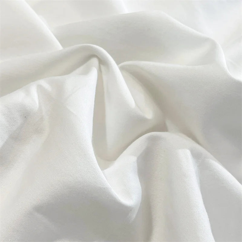 Close-up of the elegant fabric of the VibeCore Aesthetic Luxe Noir Trim Duvet Cover Set, showcasing its soft texture and sophisticated design with a contrasting black trim, perfect for adding a luxurious, modern touch to your bedroom or dorm decor.