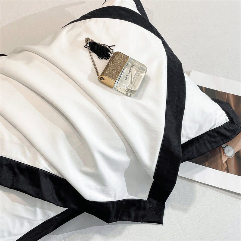 Close-up view of the premium material of the VibeCore Aesthetic Luxe Noir Trim Duvet Cover Set, highlighting its smooth texture and high-quality fabric with a striking black trim, adding a refined and luxurious touch to your bedding.