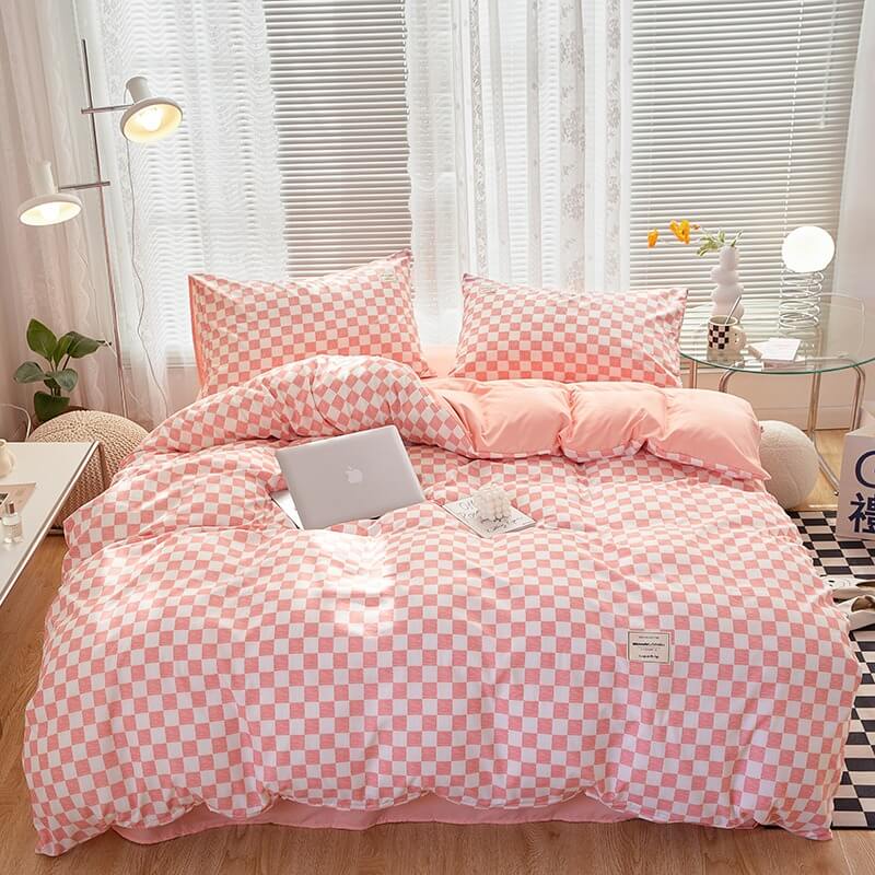 Aerial view of the 'VibeCore Aesthetic Mini Checkered Duvet Cover Set' in Baby Pink, showcasing the modern checkered pattern across the duvet cover and soft, high-quality fabric. The sleek design and fresh color create a chic, stylish atmosphere perfect for any bedroom or dorm.