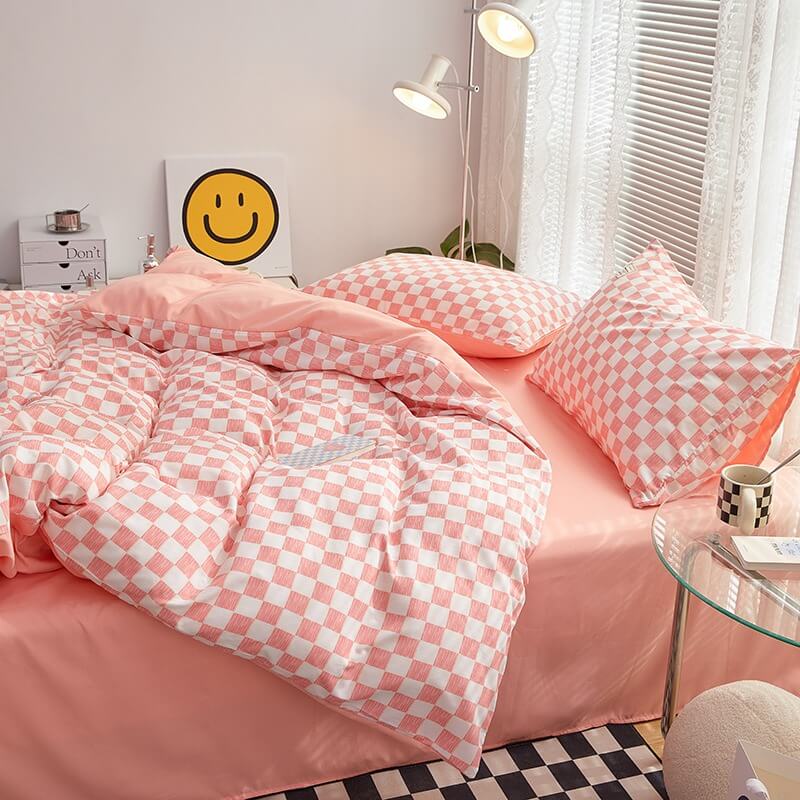Side right view of the 'VibeCore Mini Checkered Bedding Set' in Baby Pink, showcasing the sleek, modern checkered pattern. The soft fabric and trendy design create a stylish and comfortable vibe, making it a perfect addition to any bedroom or dorm.