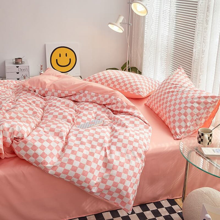 Side right view of the 'VibeCore Mini Checkered Bedding Set' in Baby Pink, showcasing the sleek, modern checkered pattern. The soft fabric and trendy design create a stylish and comfortable vibe, making it a perfect addition to any bedroom or dorm.