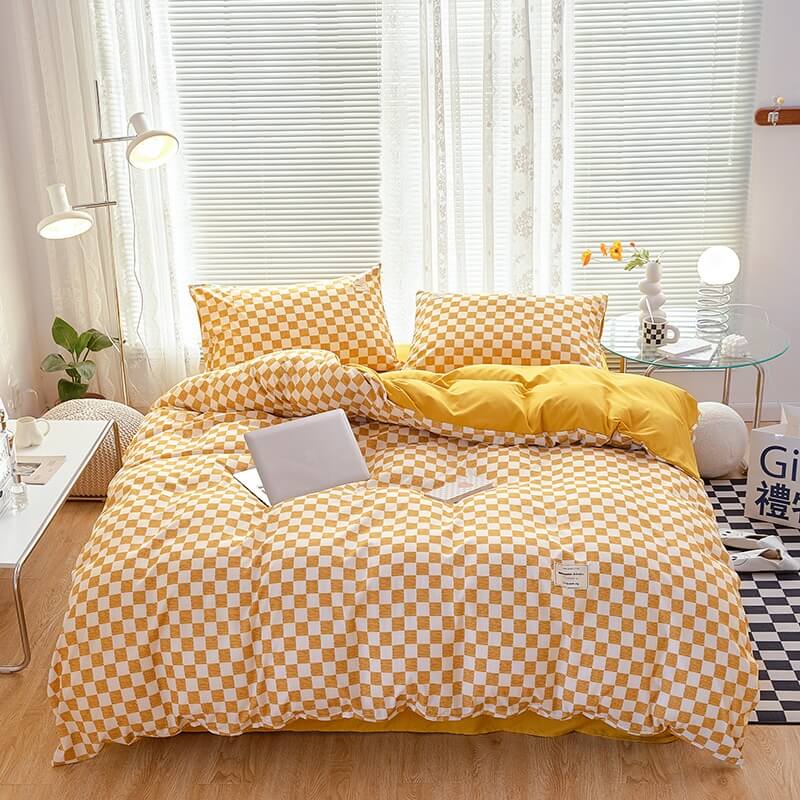 Aerial view of the 'VibeCore Aesthetic Mini Checkered Duvet Cover Set' in Mustard Yellow, showcasing the modern checkered pattern across the duvet cover and soft, high-quality fabric. The sleek design and fresh color create a chic, stylish atmosphere perfect for any bedroom or dorm.
