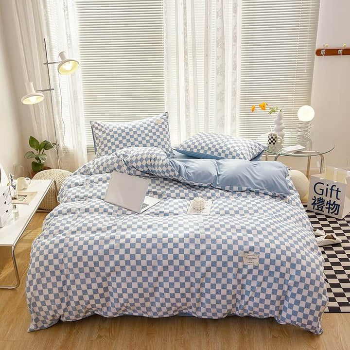 Aerial view of the 'VibeCore Aesthetic Mini Checkered Duvet Cover Set' in Sky Blue, showcasing the modern checkered pattern across the duvet cover and soft, high-quality fabric. The sleek design and fresh color create a chic, stylish atmosphere perfect for any bedroom or dorm.
