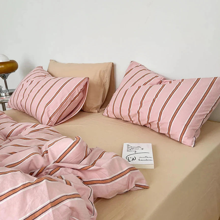 Close-up of the pillow covers and striped pattern on the VibeCore Pink Stripe Bedding Set, crafted from 100% breathable cotton. The playful pink stripes add a modern touch, blending cozy comfort with effortless style, perfect for enhancing your bedroom or dorm decor.