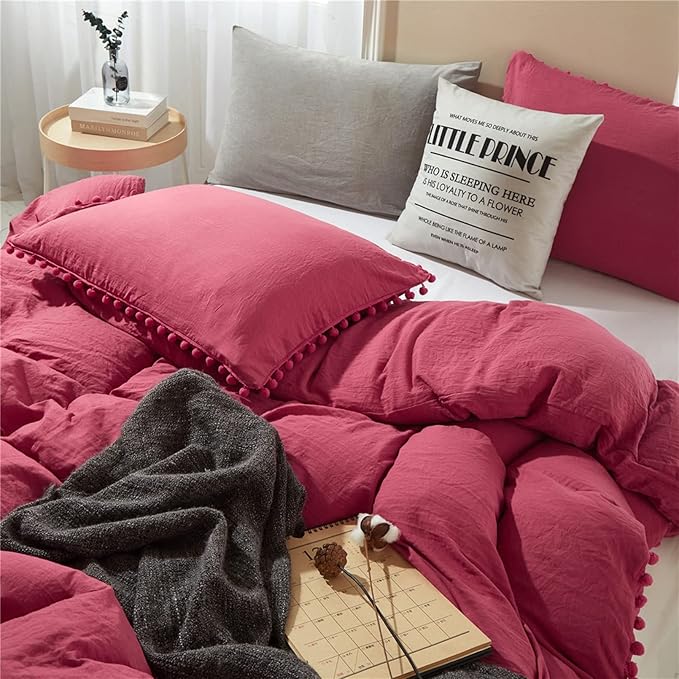 Aerial side view of the VibeCore Aesthetic PomPom Duvet Cover Set in dusty rose, showcasing the soft pom-pom accents along the edges. Made from soft, breathable fabric, this duvet set brings a playful, cozy touch to any bedroom or dorm, with a fresh, light aesthetic.
