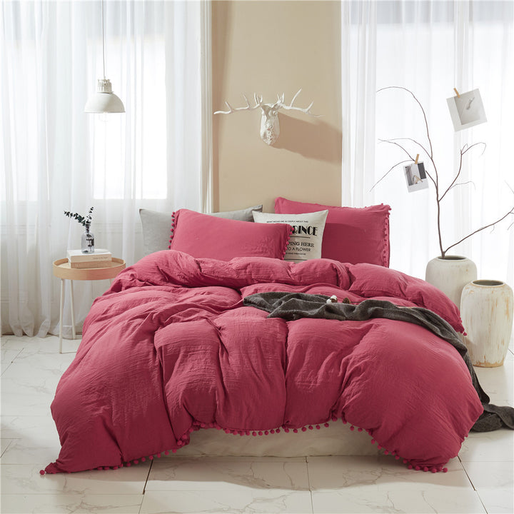 Front view of the VibeCore Aesthetic PomPom Duvet Cover Set in dusty rose, showcasing the soft pom-pom accents along the edges. Crafted from cozy, breathable fabric, this duvet set adds a warm, inviting touch to any bedroom or dorm with its deep pink hue.