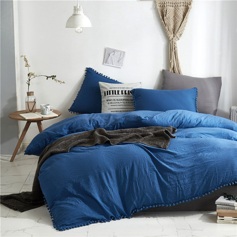 Aerial view of the VibeCore Aesthetic PomPom Duvet Cover Set in navy blue, featuring soft pom-pom accents that add a playful and cozy touch. Crafted from soft, breathable fabric, this duvet set brings a fresh, light, and inviting aesthetic to any bedroom or dorm.