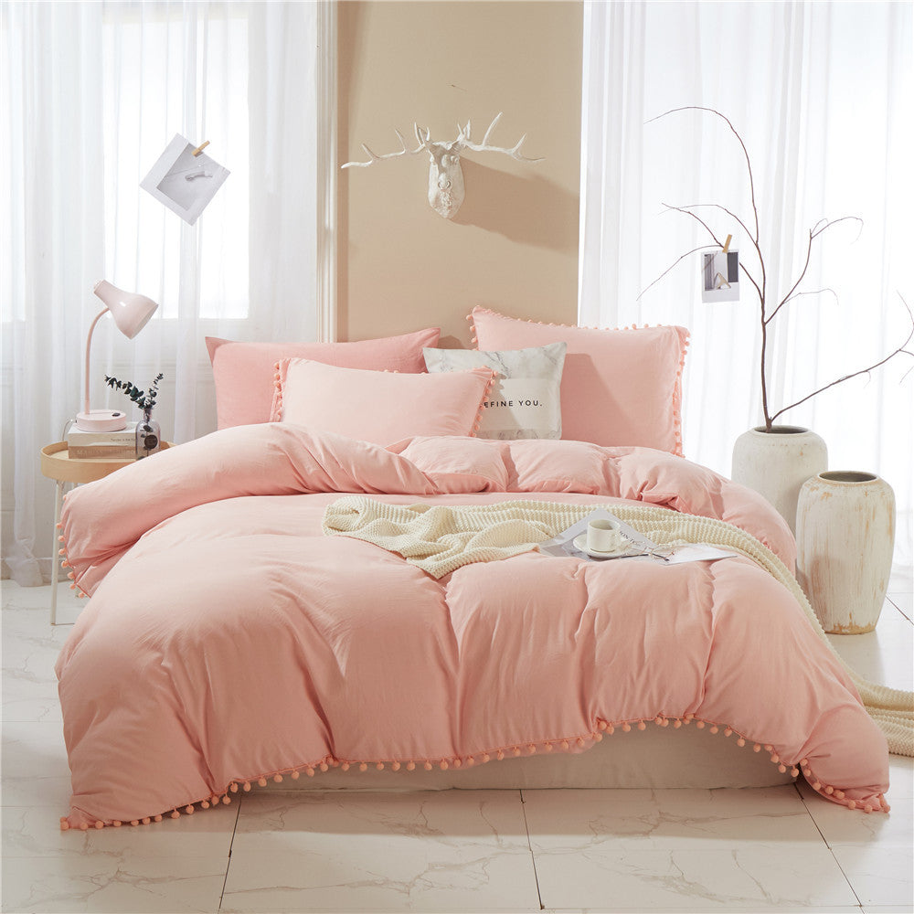 Front view of the VibeCore Aesthetic PomPom Duvet Cover Set in rose, showcasing the soft pom-pom accents along the edges. Crafted from breathable, cozy fabric, this duvet set adds a playful and inviting touch to any bedroom or dorm, with a warm, soft pink hue.