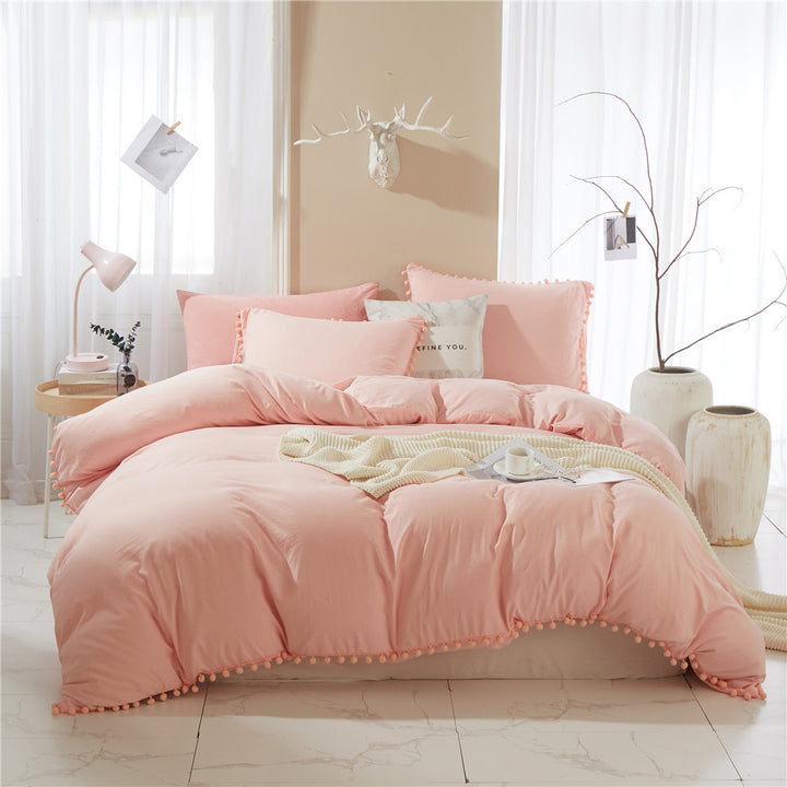Front view of the VibeCore Aesthetic PomPom Duvet Cover Set in rose, showcasing the soft pom-pom accents along the edges. Crafted from breathable, cozy fabric, this duvet set adds a playful and inviting touch to any bedroom or dorm, with a warm, soft pink hue.