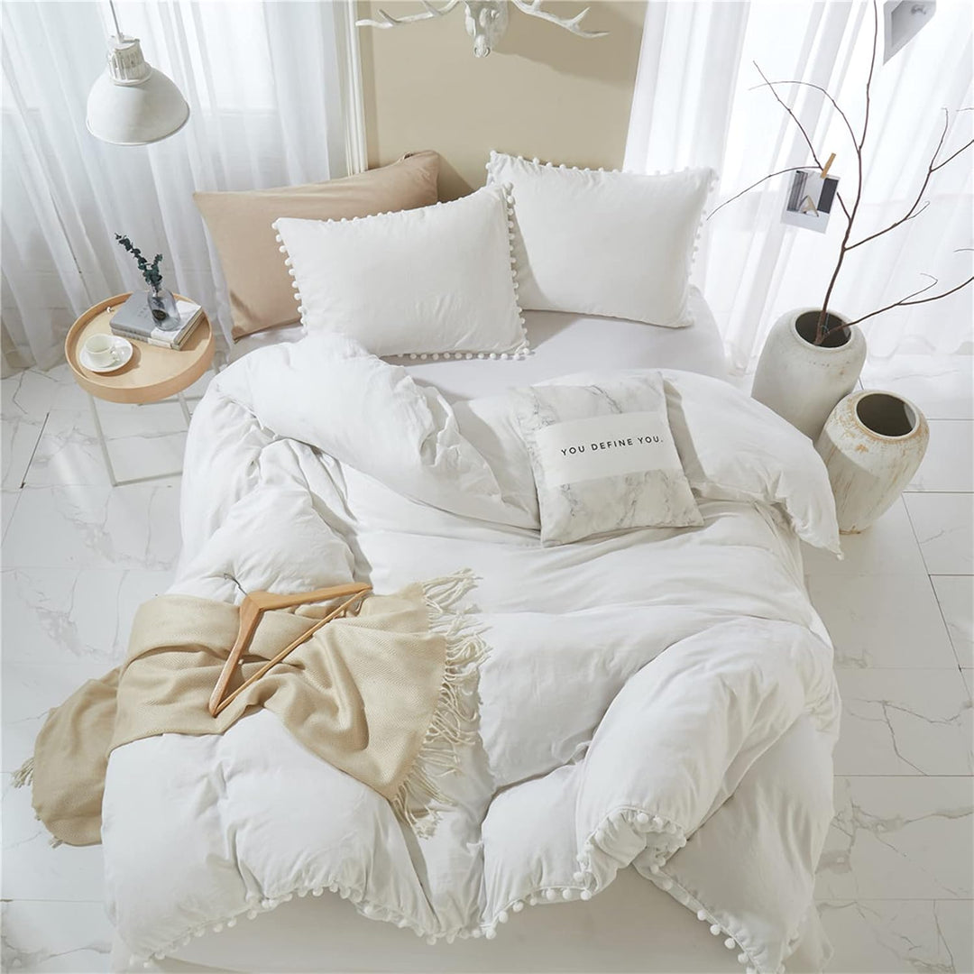 Aerial view of the VibeCore Aesthetic PomPom Duvet Cover Set in white featuring soft pom-pom accents that add a playful and cozy touch. Crafted from soft, breathable fabric, this duvet set brings a fresh, light, and inviting aesthetic to any bedroom or dorm.