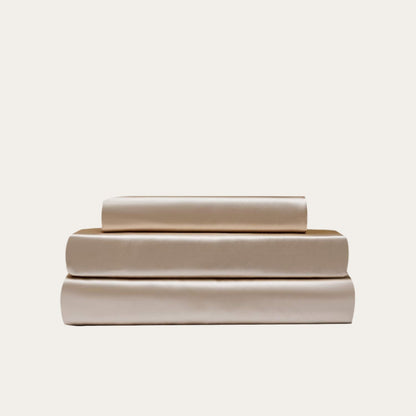 VibeCore Aesthetic Sleek Satin Duvet Cover Set in beige, showcasing the complete sheet package including duvet cover, flat sheet, and pillowcases, designed for a luxurious and smooth bedroom and dorm experience.
