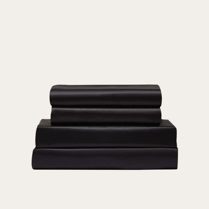 VibeCore Aesthetic Sleek Satin Duvet Cover Set in black, showcasing the complete sheet package including duvet cover, flat sheet, and pillowcases, designed for a luxurious and smooth bedroom and dorm experience.
