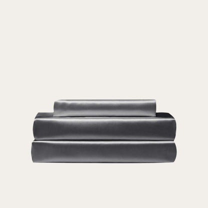 VibeCore Aesthetic Sleek Satin Duvet Cover Set in dark gray, showcasing the complete sheet package including duvet cover, flat sheet, and pillowcases, designed for a luxurious and smooth bedroom and dorm experience.