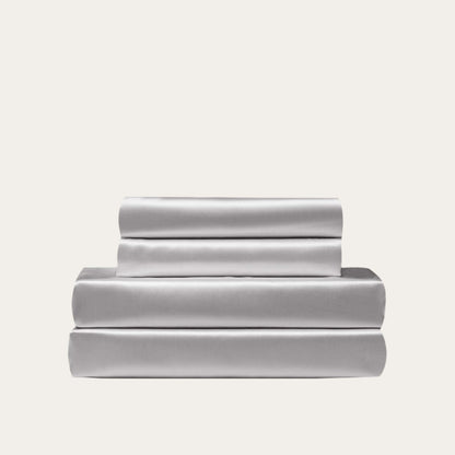 VibeCore Aesthetic Sleek Satin Duvet Cover Set in gray, showcasing the complete sheet package including duvet cover, flat sheet, and pillowcases, designed for a luxurious and smooth bedroom and dorm experience.
