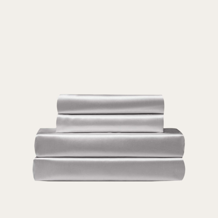 VibeCore Aesthetic Sleek Satin Duvet Cover Set in gray, showcasing the complete sheet package including duvet cover, flat sheet, and pillowcases, designed for a luxurious and smooth bedroom and dorm experience.
