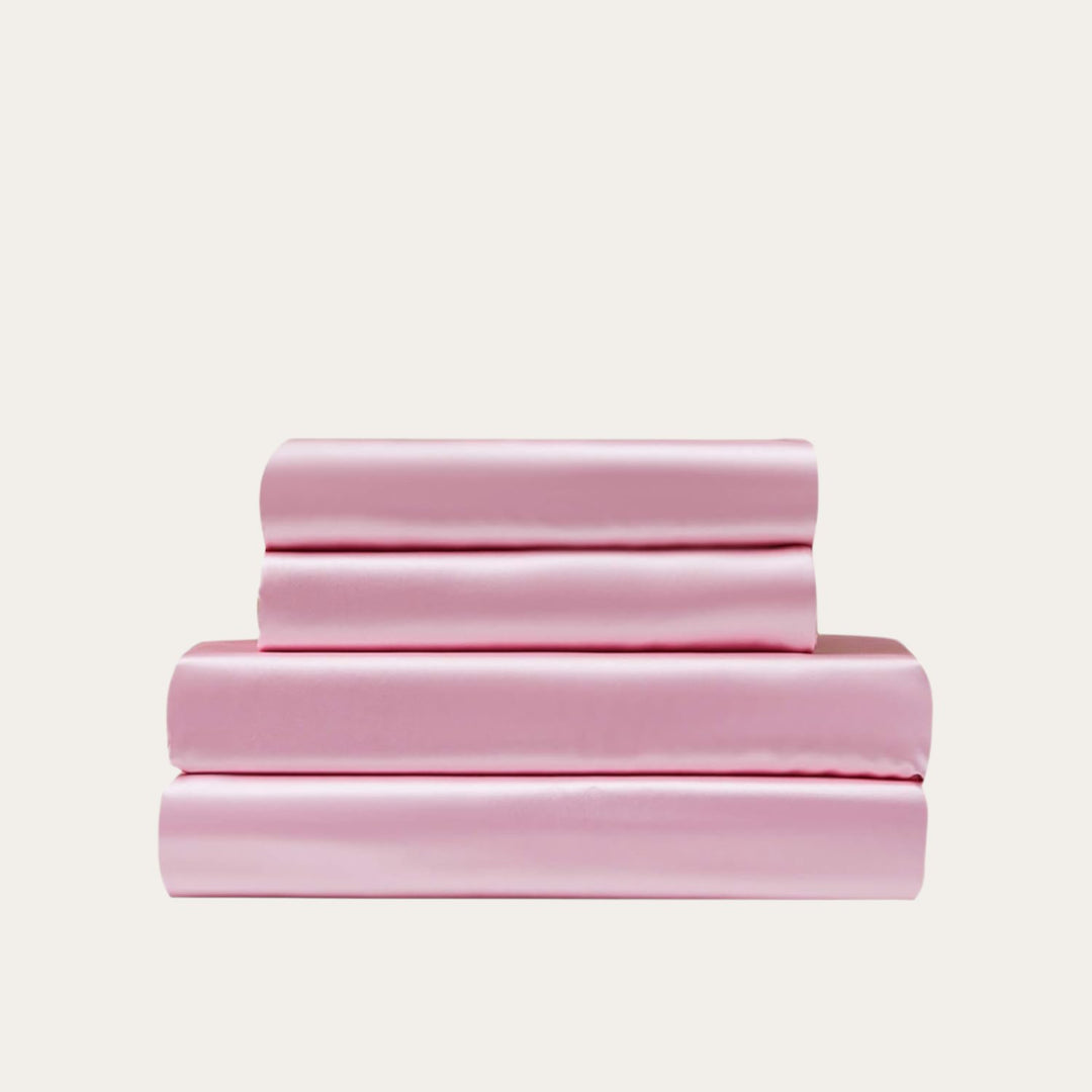 VibeCore Aesthetic Sleek Satin Duvet Cover Set in pink, showcasing the complete sheet package including duvet cover, flat sheet, and pillowcases, designed for a luxurious and smooth bedroom and dorm experience.
