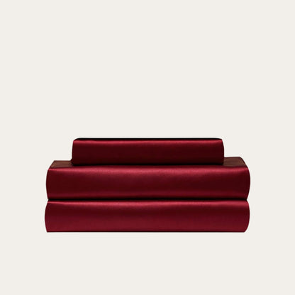 VibeCore Aesthetic Sleek Satin Duvet Cover Set in wine red, showcasing the complete sheet package including duvet cover, flat sheet, and pillowcases, designed for a luxurious and smooth bedroom and dorm experience.
