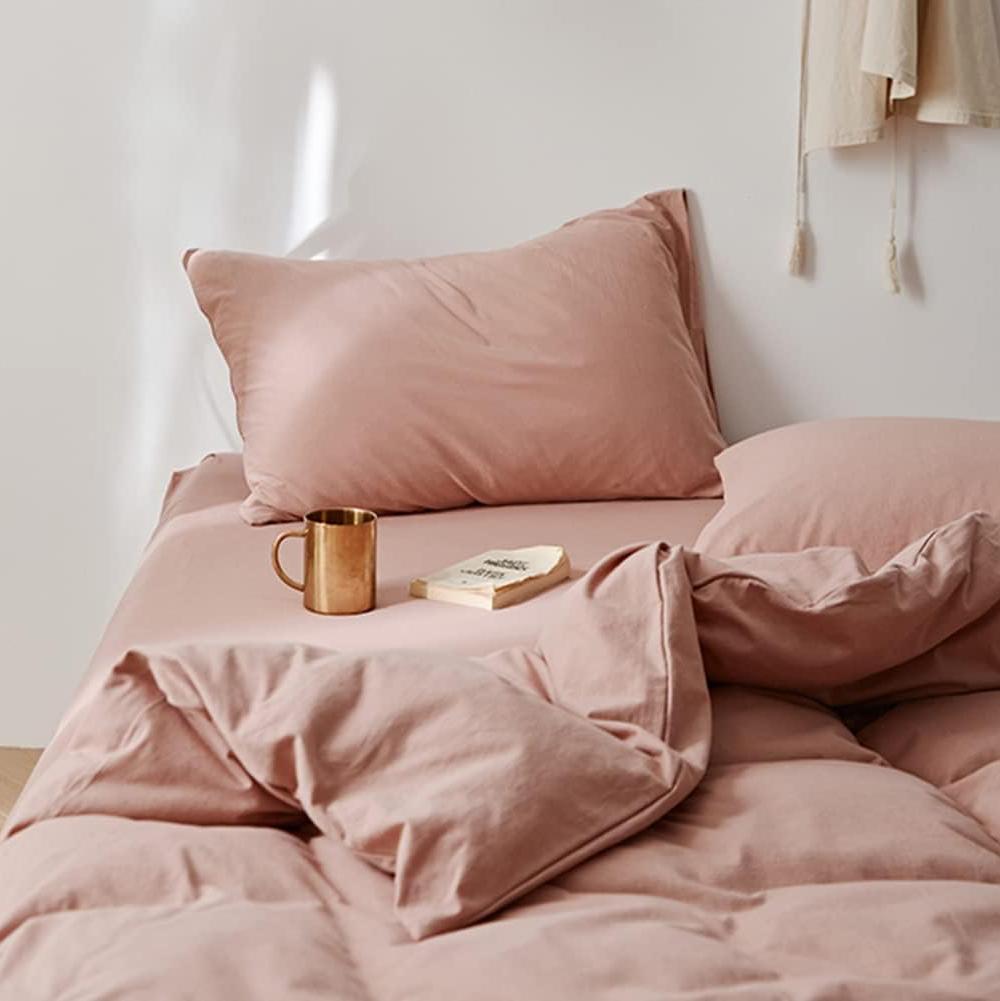 Top right view of the VibeCore Aesthetic Solid Comfort Duvet Cover Set in Baby Pink, highlighting its clean, minimalist design and soft, plush texture that enhances the cozy, calming atmosphere of any bedroom or dorm.