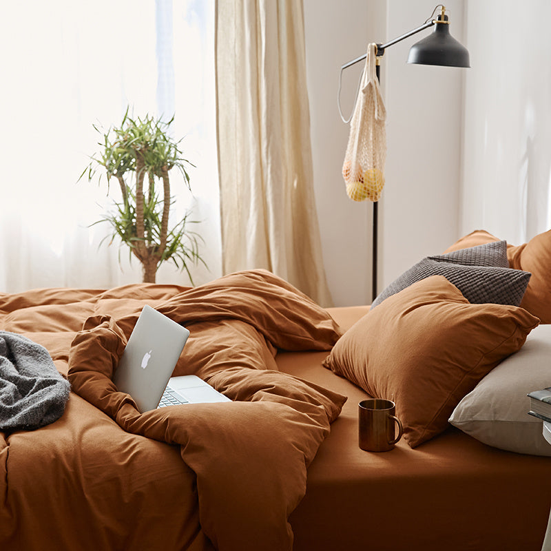Side view of the VibeCore Aesthetic Solid Comfort Duvet Cover Set in Burnt Orange, highlighting its rich, warm tone and sleek, minimalist design for a cozy yet bold bedroom upgrade.