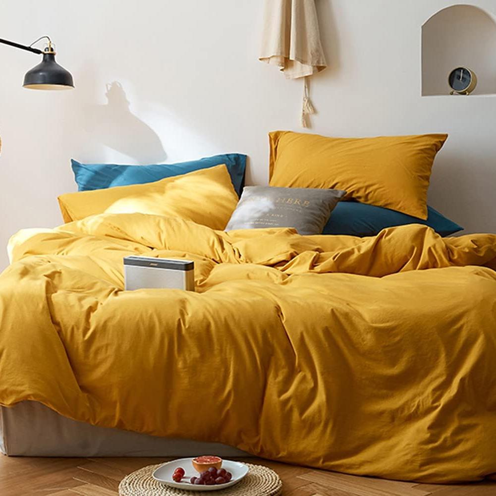 VibeCore Aesthetic Solid Comfort Duvet Cover Set in Mustard Yellow, showcasing the full set from above. The rich, warm color and smooth texture add a touch of cozy elegance to your bedroom or dorm.