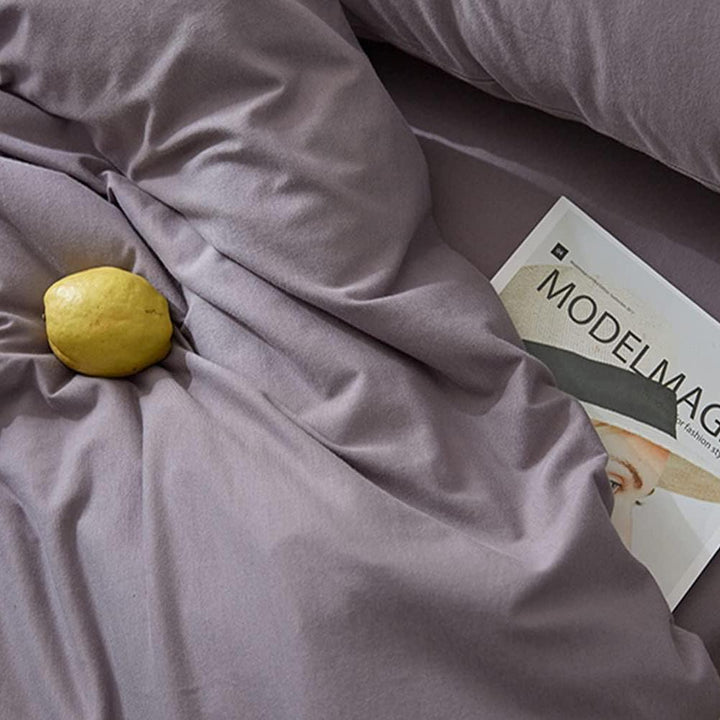 VibeCore Aesthetic Solid Comfort Duvet Cover Set Purple Gray Material close-up, showcasing the soft, breathable fabric in a soothing purple-gray tone, perfect for creating a cozy and stylish bedroom or dorm atmosphere.