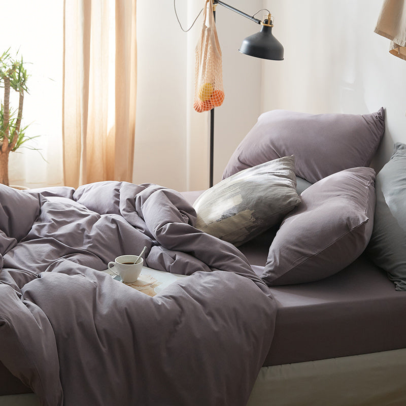VibeCore Aesthetic Solid Comfort Duvet Cover Set in Purple Gray, shown from the side to highlight the soft texture and subtle, modern color. This sleek duvet cover adds a calming touch to any bedroom or dorm.